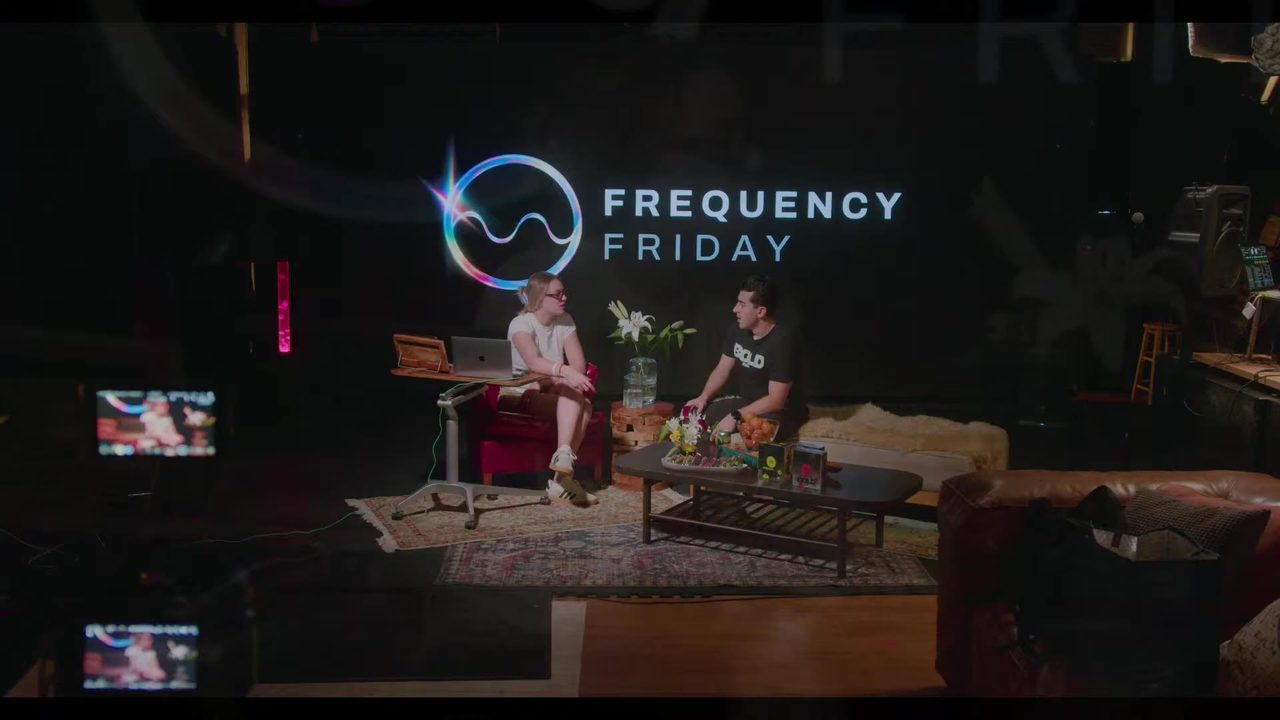Taylor and a guest talking on the Living Room couch